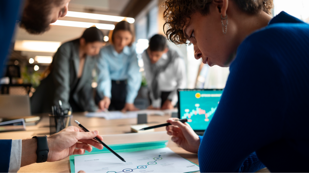 people analyzing checking finance graphs office