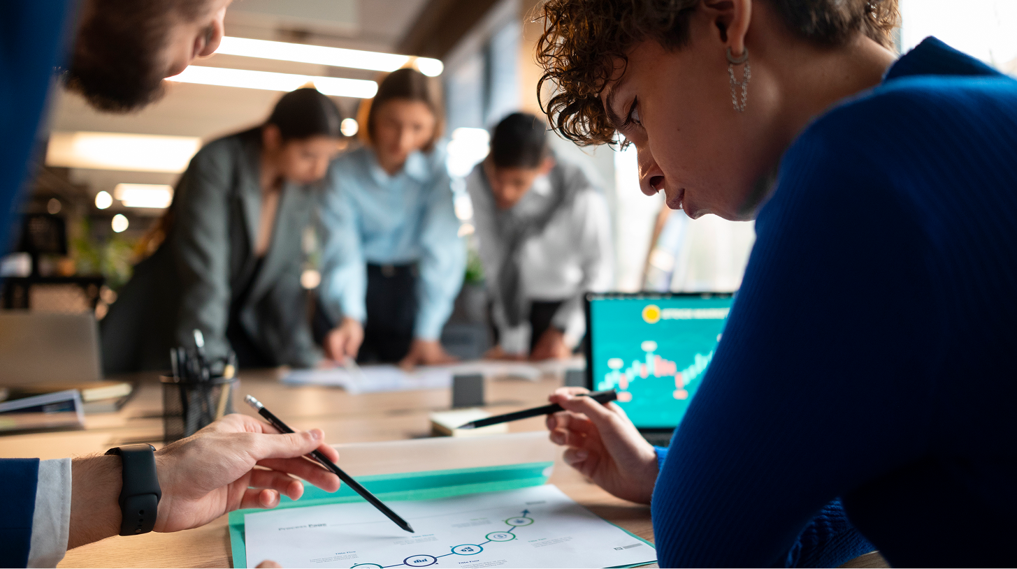 people analyzing checking finance graphs office