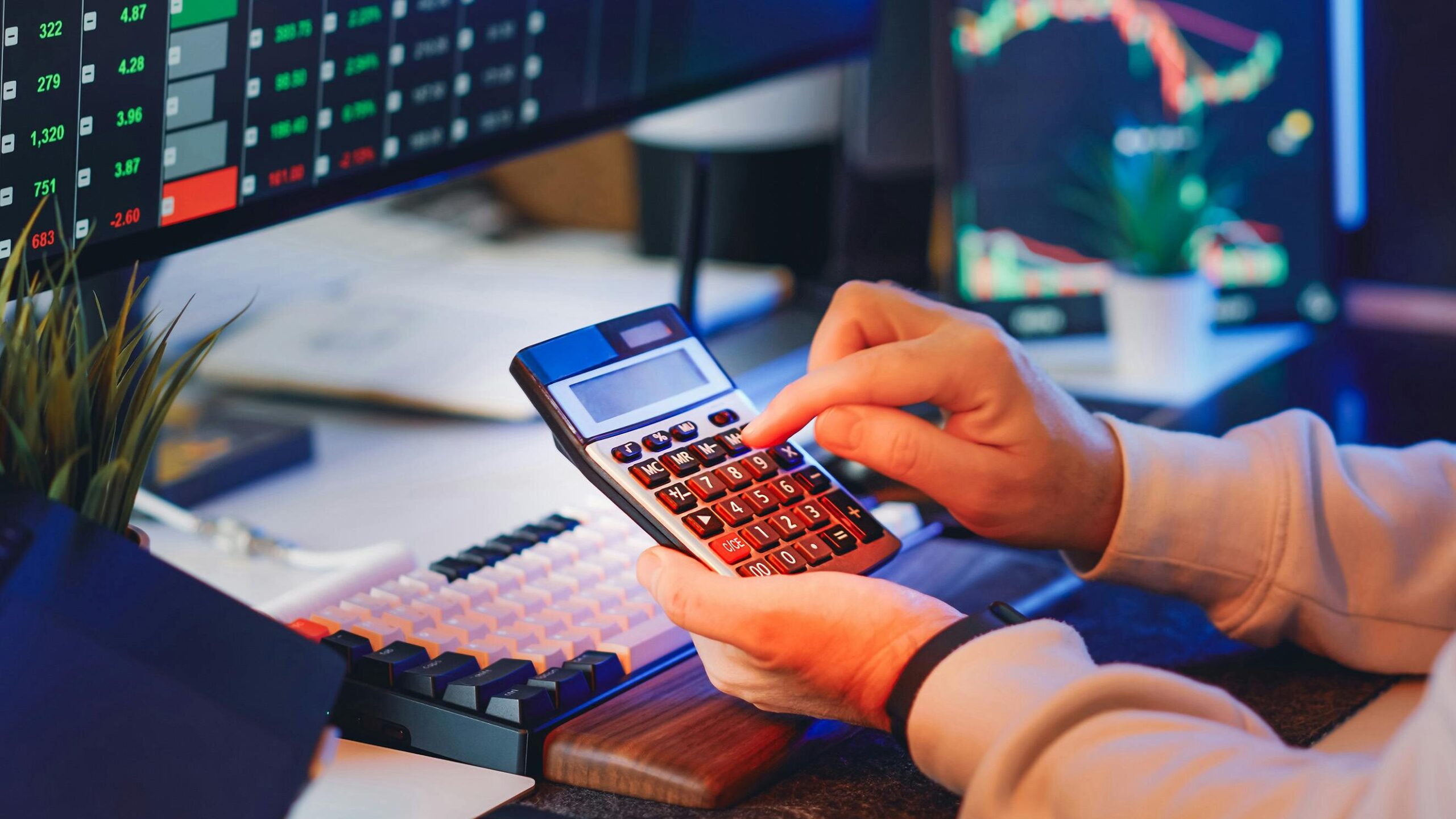 A man calculating profit with a calculator.